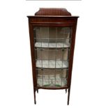 AN EARLY 20TH CENTURY MAHOGANY DISPLAY CABINET With a single bow fronted lead glazed door, raised on