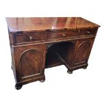 A VICTORIAN MAHOGANY DRESSER With three drawers above central kennel, flanked by cupboards, on bun