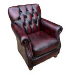 AN EDWARDIAN STYLE LIBRARY ARMCHAIR In oxblood leather button back upholstery. (79cm x 73cm x