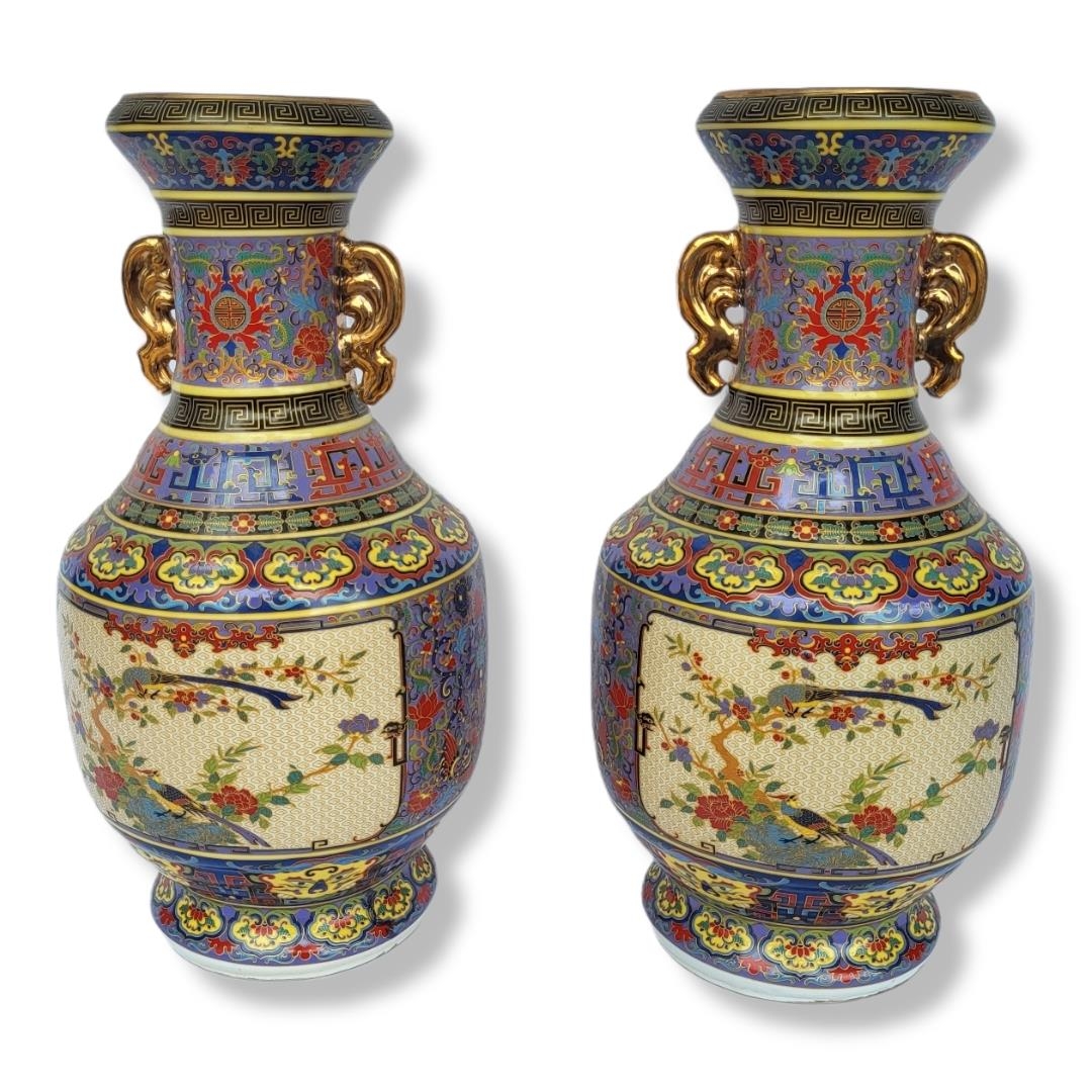 A PAIR OF CHINESE CERAMIC VASES Doubled eared gilded handles with famille rose style polychrome