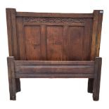 AN ANTIQUE OAK 4FT BEDSTEAD With carved and plain panels. (headboard 123cm x 116cm) Condition