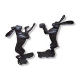 A PAIR OF LARGE CAST BRONZE BOXING HARES Depicting a larger than life pair of pugilistic hares on