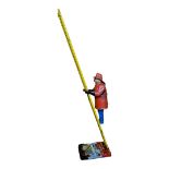 LOUIS MARX, A VINTAGE 1950’S TIN WIND UP CLIMBING FIREMAN TOY Consisting of a fireman, ladder (in