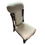 A VICTORIAN WALNUT PRIE DU CHAIR With upholstered and seat and back, pierced and carved frame, on