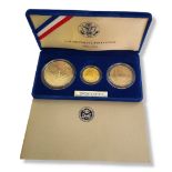 AN AMERICAN 22CT GOLD AND SILVER THREE UNCIRCULATED COIN SET, DATED 1986 Titled 'United States