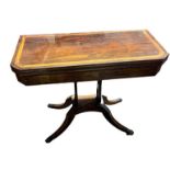 A REGENCY PERIOD ROSEWOOD AND SATINWOOD BANDED FOLD OVER CARD TABLE With green baize playing