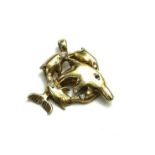 A VINTAGE YELLOW METAL DOLPHIN PENDANT Having a pierced design set with round cut paste stones. (