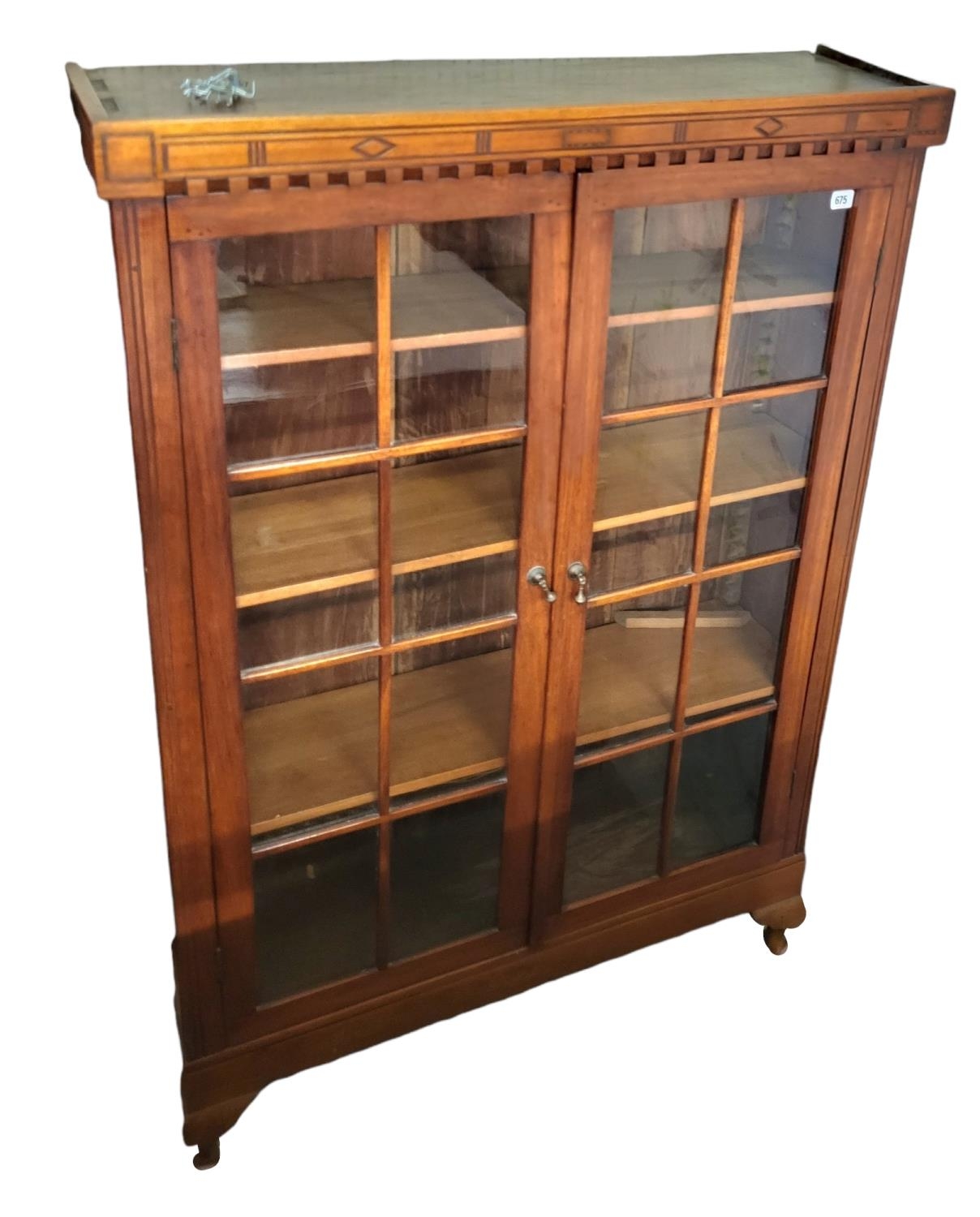 AN EARLY 20TH CENTURY MAHOGANY FLOOR STANDING BOOKCASE With two glazed doors enclosing adjustable