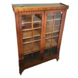 AN EARLY 20TH CENTURY MAHOGANY FLOOR STANDING BOOKCASE With two glazed doors enclosing adjustable