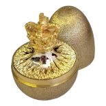 STUART DEVLIN, A SILVER GILT SURPRISE EGG Having a textured finish to exterior and Royal Crown to