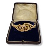 A VICTORIAN 9CT GOLD BANGLE Entwined knot design in a fitted velvet lined leather box. (approx 6.