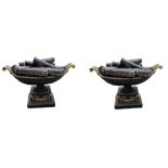 A PAIR OF REGENCY DESIGN CAST IRON AND BRASS MOUNTED URNS With rams head mounts and swags