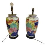 A PAIR OF TALL CERAMIC BALUSTER SHAPE LAMP BASES Decorated with polychrome floral and leafy pattern.