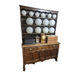 A VICTORIAN AND LATER OAK DRESSER With open shelves above drawers and cupboards. (136cm x 36cm x