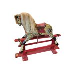 A VINTAGE DAPPLE GREY PAINTED PINE HADDON ROCKING HORSE With real hair mane and tail and leather