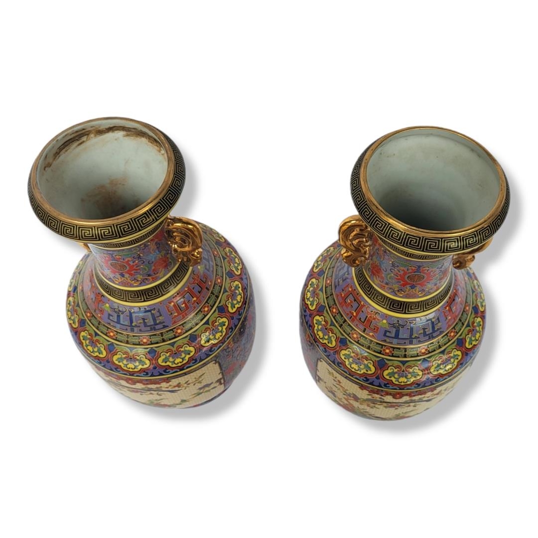 A PAIR OF CHINESE CERAMIC VASES Doubled eared gilded handles with famille rose style polychrome - Image 2 of 3