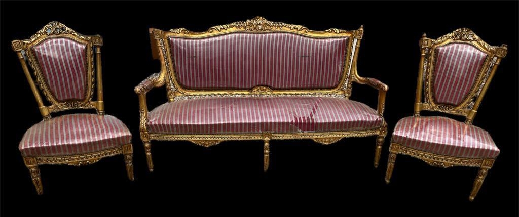 A FRENCH EMPIRE STYLE GILTWOOD SETTEE Together with a pair of matching chairs, decorated with carved