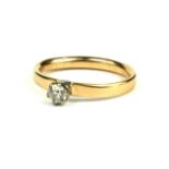 AN 18CT GOLD AND DIAMOND SOLITAIRE RING The single round cut stone on a plain gold shank. (diamond