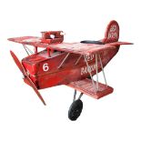 A VINTAGE FIBREGLASS RED BARON BIPLANE FAIRGROUND ATTRACTION RIDE Painted red, white and black. (