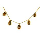 A YELLOW METAL AND TIGER'S EYE PENDANT NECKLACE Five graduating cabochon cut oval tigers eye drops