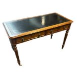 A VICTORIAN OAK WRITING TABLE With black tooled leather top above two drawers, raised on turned legs