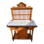 A LATE 19TH CENTURY PINE AND MARBLE WASHSTAND Having a pierced carved back set with eight ceramic