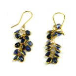 A PAIR OF YELLOW METAL AND SAPPHIRE DROP EARRINGS Having an arrangement of oval cut stones. (tests