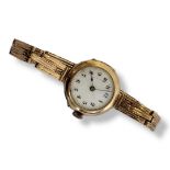 AN EARLY 20TH CENTURY 9CT GOLD LADIES WRISTWATCH Circular white dial with blue twelve and Arabic