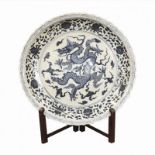 A LARGE CERAMIC CHINESE BLUE & WHITE CHARGER/PLATE Decorated with a dragon and a Phoenix, together