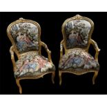 A PAIR OF BAROQUE STYLE GILTWOOD TAPESTRY SALON CHAIRS Upholstery depicting courting couples. (