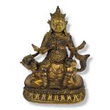 VAISRAVANA (JAMBHALA), A GILT BRONZE BUDDHIST STATUE Seated on a snow lion mount, a Tibetan Chief of