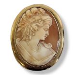 A VINTAGE 9CT GOLD OVAL CAMEO BROOCH Carved with a classical female portrait in a wide 9ct gold