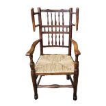 A 19TH CENTURY YORKSHIRE WING ARMCHAIR With turned spindle rails and rush seat. (57cm x 55cm x