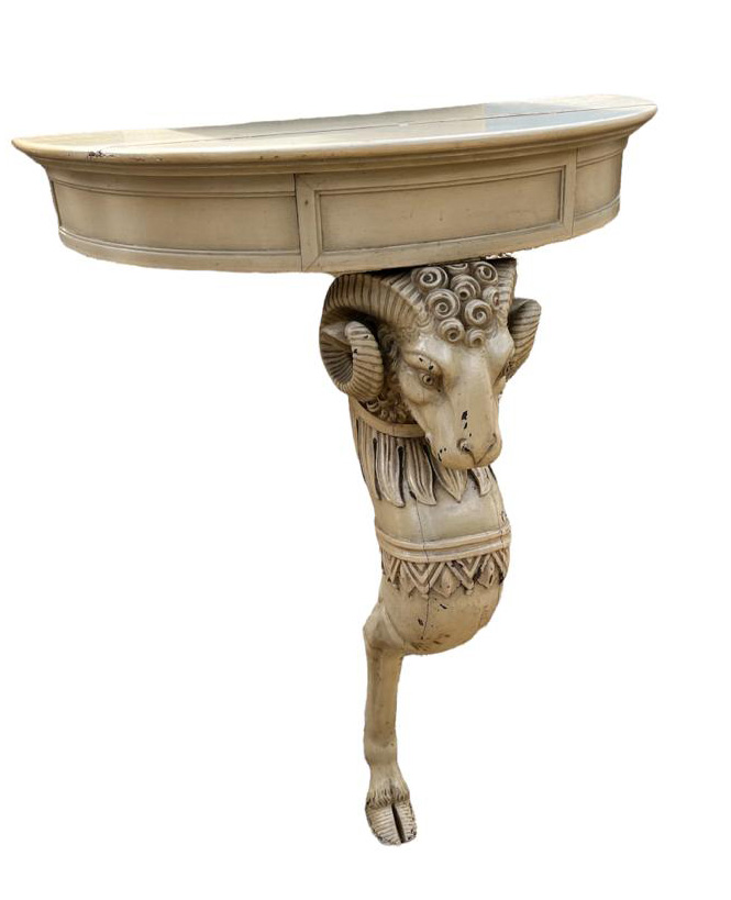 A 19TH CENTURY AND LATER PAINTED PINE DEMILUNE CONSOLE TABLE With single finely carved rams head leg