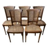 A SET OF FOUR AMERICAN FAUX WALNUT AND CANE DINING CHAIRS. (48cm x 46cm x 69cm) Condition: some