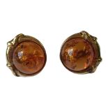 A PAIR OF 9CT GOLD AND AMBER EARRINGS Marked 375 to back, a round amber cabochon encircled with an
