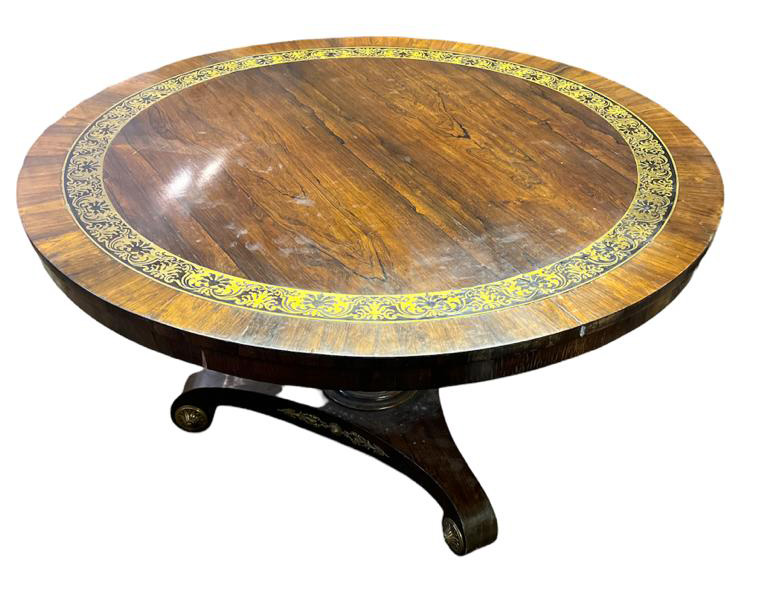 A REGENCY PERIOD ROSEWOOD AND BRASS INLAID BREAKFAST TABLE The circular top on turned column with