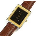 OMEGA, DEVILLE, AN 18CT GOLD AND STAINLESS STEEL GENT’S WRISTWATCH Rectangular tank form with 18ct