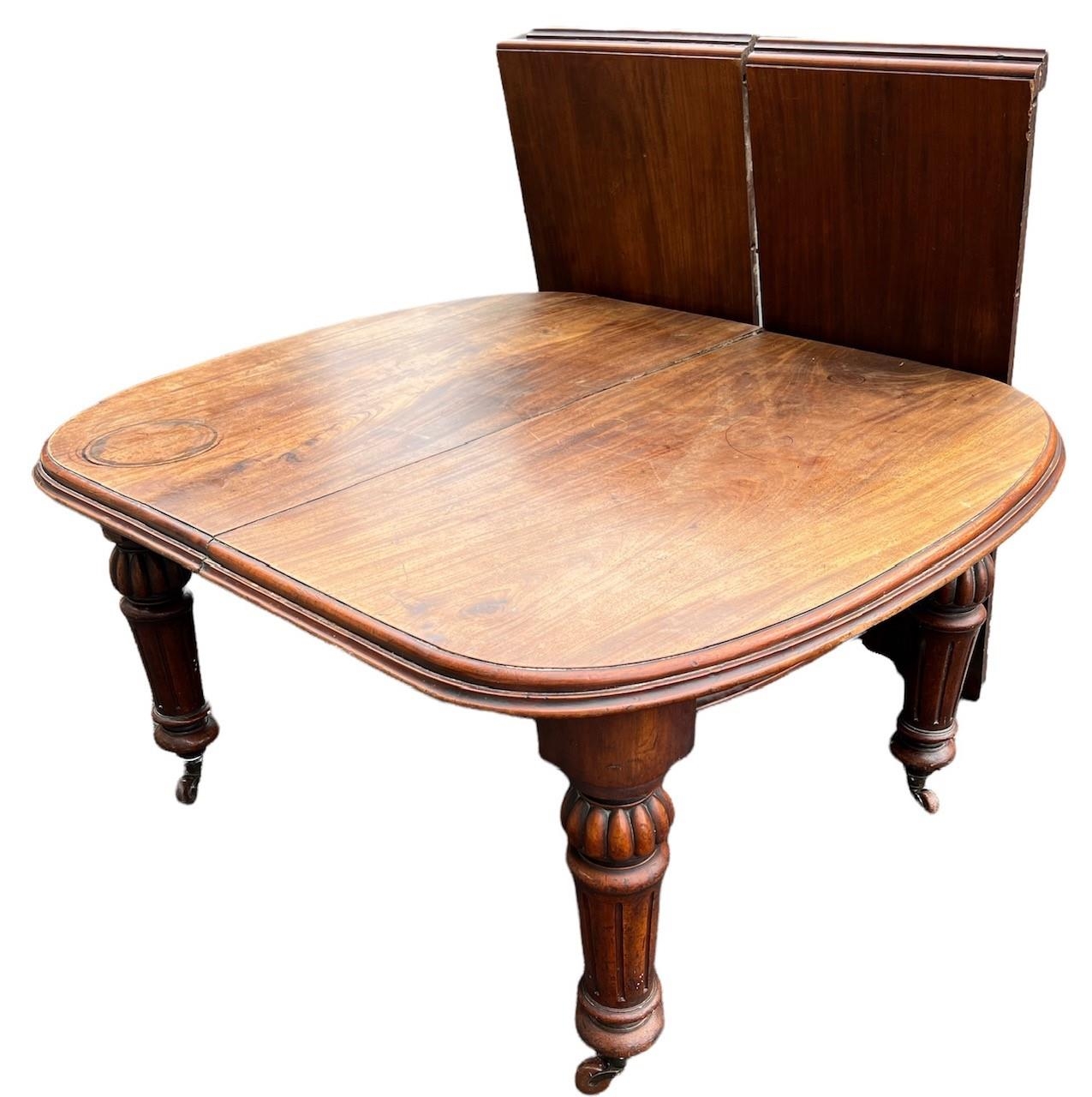 A 19TH CENTURY SOLID MAHOGANY EXTENDING DINING TABLE With two extra leaves, raised on bulbous and - Image 3 of 3