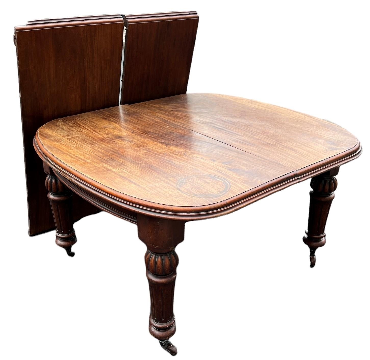 A 19TH CENTURY SOLID MAHOGANY EXTENDING DINING TABLE With two extra leaves, raised on bulbous and - Image 2 of 3