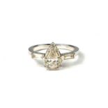 A PEAR, BAGUETTE AND ROUND BRILLIANT CUT DIAMOND CLUSTER RING Set in a 9ct white gold. (diamonds 0.