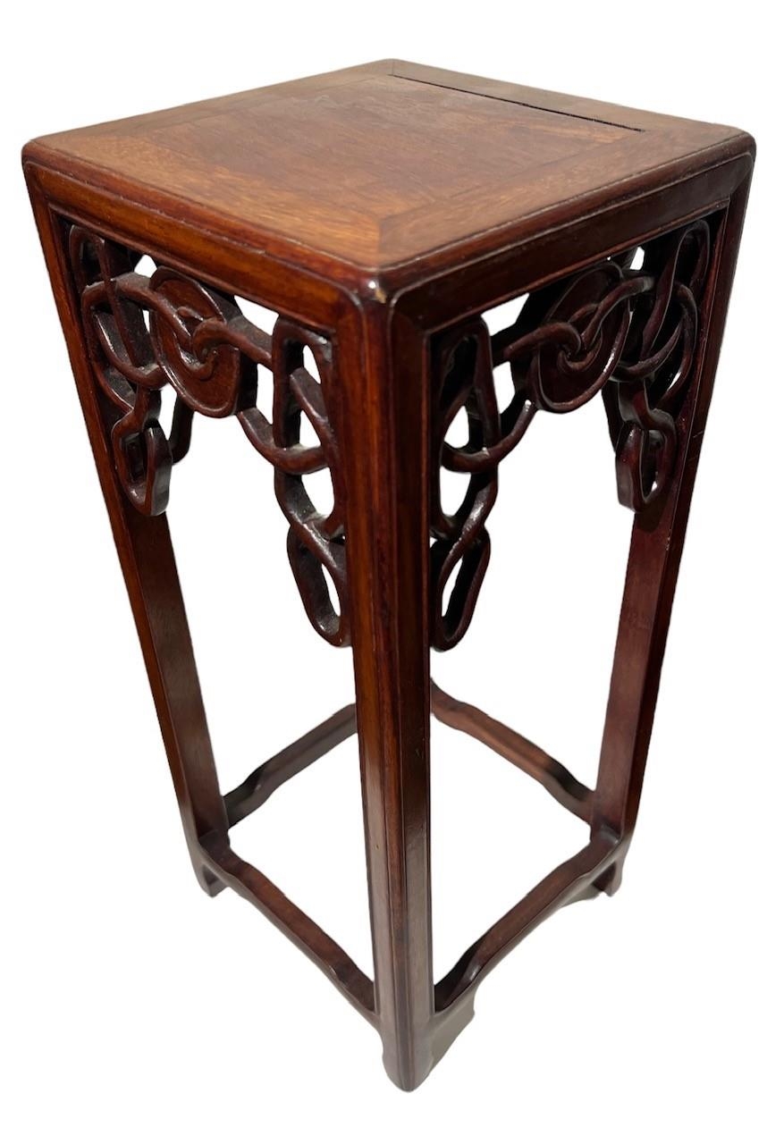A SMALL CHINESE HARDWOOD TABLE STAND The square top above a pieced frieze, raised on square
