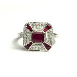 AN ART DECO STYLE 18CT WHITE GOLD, RUBY AND DIAMOND RING Flanked by diamond shoulders. (approx
