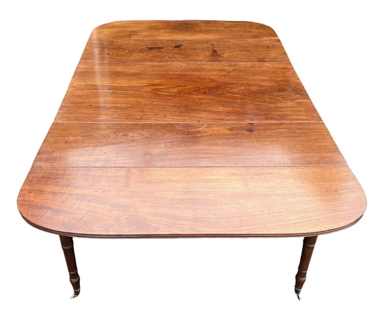 MANNER OF GILLOWS, A 19TH CENTURY SOLID MAHOGANY EXTENDING PEMBROKE DINING TABLE With concertina