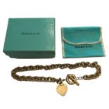 TIFFANY & CO., A STERLING SILVER CHARM BRACELET With Tiffany & Co. heart form pendant. (73.6g)