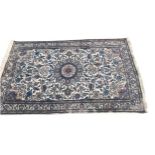 A PERSIAN RUG The central floral motif, repeating geometric floral design, on a blue and cream