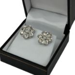 A PAIR OF 18CT WHITE GOLD AND SEVEN STONE BRILLIANT CUT DIAMOND DAISY CLUSTER EAR STUDS Boxed,