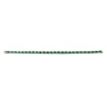 AN 18CT WHITE GOLD, OVAL CUT EMERALD AND DIAMOND LINE BRACELET. (approx emeralds 8.95ct, diamonds