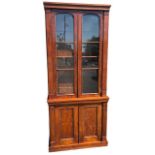 AN EARLY 19TH CENTURY MAHOGANY GLAZED BOOKCASE With shelf interior above a pair of panelled doors