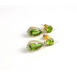 A PAIR OF YELLOW GOLD DROP EARRINGS set with pear shape and round peridot and round brilliant cut